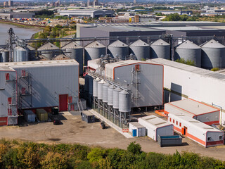 Industrial Grain Storage Facility Unloading Seed During a Clear Afternoon at the Docks © Tom