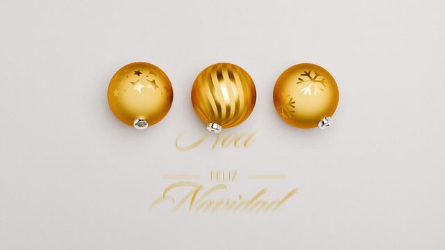 Three golden christmas baubles spinning on a paper surface. Multi language Merry Christmas messages rolling through (English, German, Spanish, French, Italian)