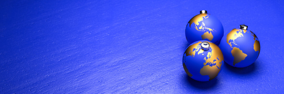 Peace on Earth at christmas concept: Blue baubles with golden continents lying on a blue stone background. Web banner format with copy space