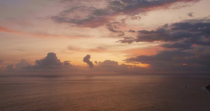 Vibrant sunset clouds and ocean horizon at twilight in Nusa Penida Bali Indonesia
