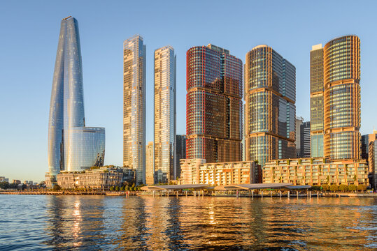 View of Barangaroo skyline and waterfront under clear blue sky at sunset in autumn. Sydney, Australia.