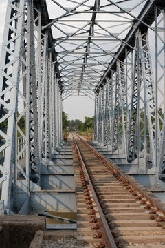 Historic Steel Railway Bridge with Railroad Tracks and Symmetrical Structure