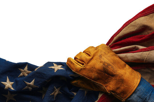 Worn work glove holding the American flag. Symbolic of hardworking blue collar workers, USA industries, pride in products Made in United States of America, or to celebrate US Labor Day. Isolated png.