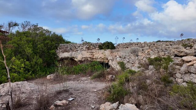 Malta, Xemxija Heritage trail - Entrance of the Punic caves near old farmers hut.
