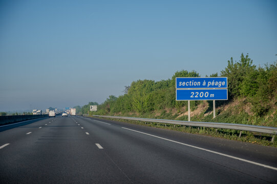 View of a French and European autoroute with overhead directional signs pointing to major cities like Paris, Bordeaux, Lille, Calais, showing lanes, traffic and motorway infrastructure, road signes