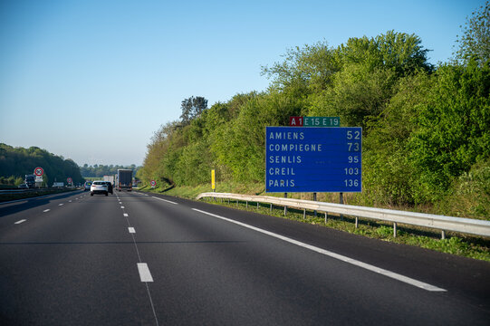 View of a French and European autoroute with overhead directional signs pointing to major cities like Paris, Bordeaux, Lille, Calais, showing lanes, traffic and motorway infrastructure, road signes
