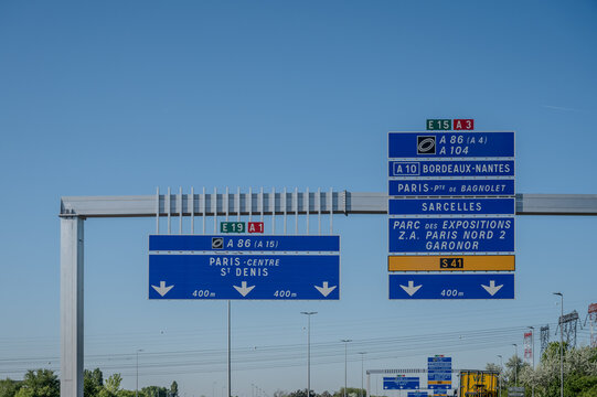 View of a French and European autoroute with overhead directional signs pointing to major cities like Paris, Bordeaux, Lille, Calais, showing lanes, traffic and motorway infrastructure, road signes