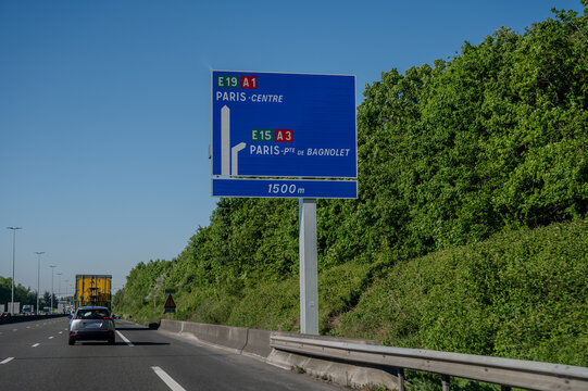 View of a French and European autoroute with overhead directional signs pointing to major cities like Paris, Bordeaux, Lille, Calais, showing lanes, traffic and motorway infrastructure, road signes