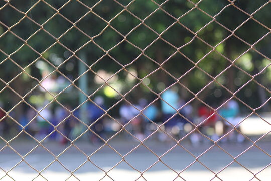 chain link fence and blurred sport court background