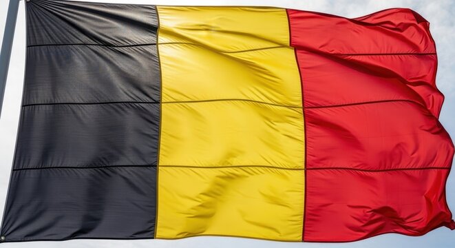 Belgian flag waving in the wind outdoors.