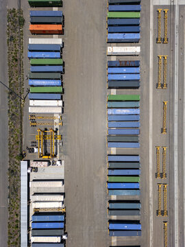Aerial view of a logistics center with rows of colorful shipping containers and industrial cranes in San Luis Potosi, San Luis Potosi, Mexico.