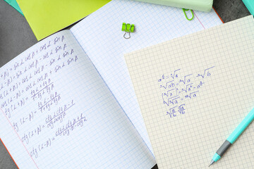 Fototapeta premium Copybooks with math formulas and stationery, closeup