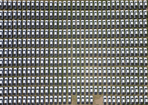 Aerial view of rows of white pickup trucks parked in a large lot at a car factory in San Luis Potosi, San Luis Potosi, Mexico.