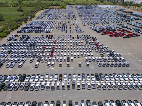 Aerial view of a car factory parking lot filled with rows of new pickup trucks in San Luis Potosi, San Luis Potosi, Mexico.