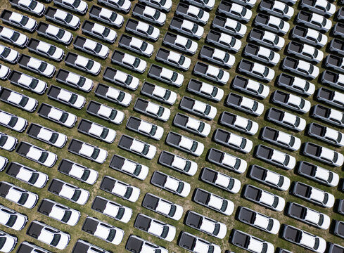 Aerial view of rows of white pickup trucks parked in a large lot at a car factory in San Luis Potosi, San Luis Potosi, Mexico.