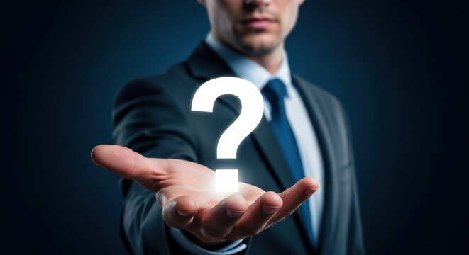 Businessman presenting glowing question mark in dark suit.