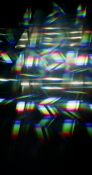 Light ray shining through a prism for angled beams of sparkling shine in brilliant colors. Swirling reflective glass with beaming lights creating visual effect of a brilliant dazzling rainbow. Loop.
