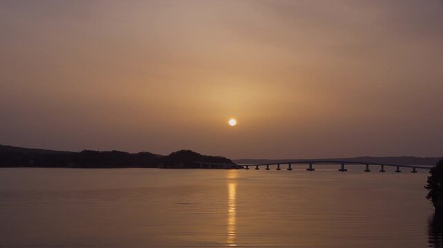 Sunrise over Noto Island and bridge in Ishikawa shrouded in yellow dust haze in 4K
