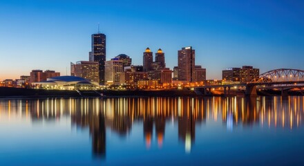 Naklejka premium City skyline reflected in calm water at dusk.