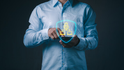 Businessman using a smartphone with virtual glowing shield and network lock. Concept of cloud computing security, cyber data protection, secure access and network privacy. © 418 House