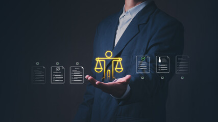 Businessman holding virtual scale of justice and document graphics. Concept of regulatory...