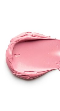 Close up of smooth pink cream texture on white background.