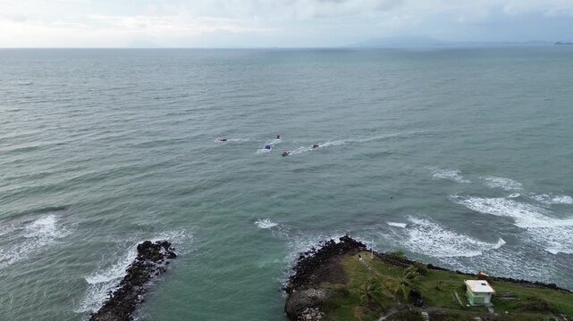 Scenic drone flight over Anyer Beach featuring gentle waves and a tropical shoreline in Banten, Indonesia.