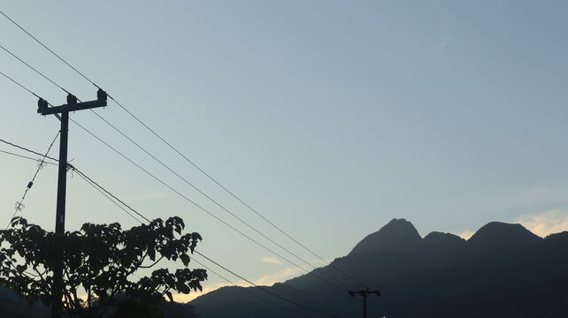 Network of electric cables on electric poles with a clear blue sky in the afternoon
