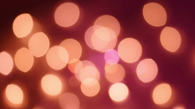 Warm Orange and Pink Bokeh Light Particles on Dark Abstract Background