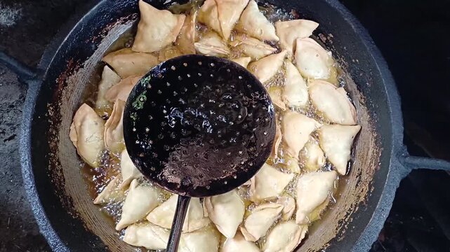 Deep Frying Samosa Singara Snacks In Boiling Hot Oil Overhead Close Up Shot