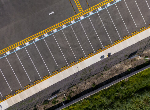 Aerial view of the logistic center parking lot with numbered spaces and yellow markings in Santiago de Queretaro, Queretaro, Mexico.