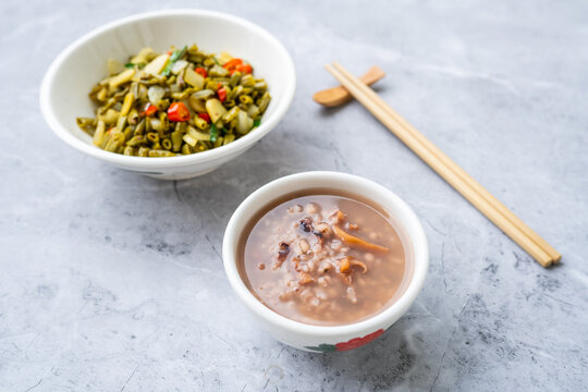 A bowl of cuttlefish and Job's-tears porridge served with stir-fried sour long beans.