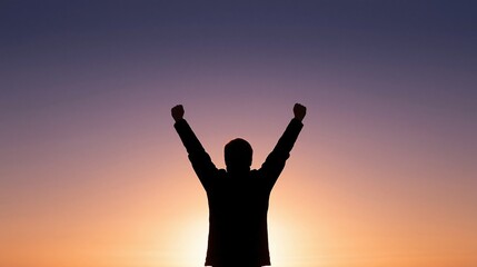 Fototapeta premium Silhouette of a person raising arms in triumph against a vibrant sunset sky with purple and orange hues.