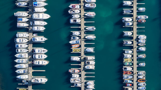 Aerial view of Snarfari Dock in Reykjavik, featuring rows of yachts and motorboats moored at wooden piers in the deep blue harbor, Reykjavik, Reykjavikurborg, Iceland.