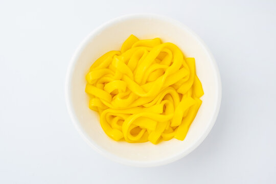 A bowl of golden-yellow corn starch noodles