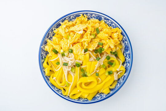 A plate of eggs, corn, and vermicelli
