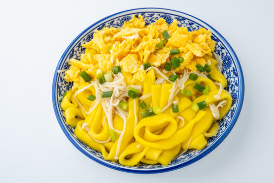 A plate of eggs, corn, and vermicelli