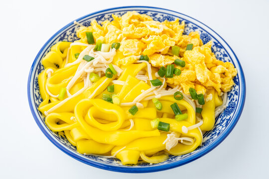 A plate of eggs, corn, and vermicelli