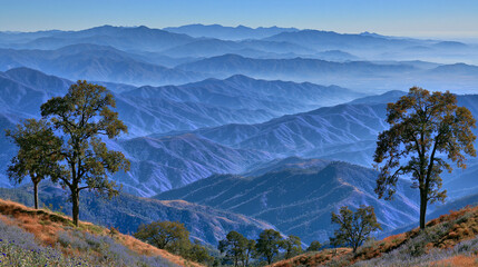 Naklejka premium Breathtaking panoramic view of distant blue mountain ranges fading into morning mist