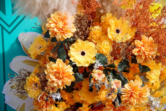 Artificial  dahlia flowers blooming on wall background
