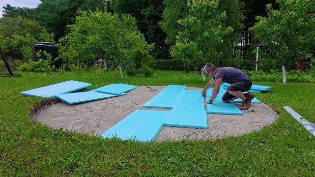 Preparing the ground and placing foam panels for a pool foundation in the backyard