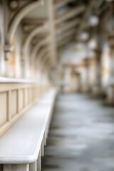 Fototapeta premium Blurred architectural interior with cream benches and arched ceiling structure in a historic building hallway.