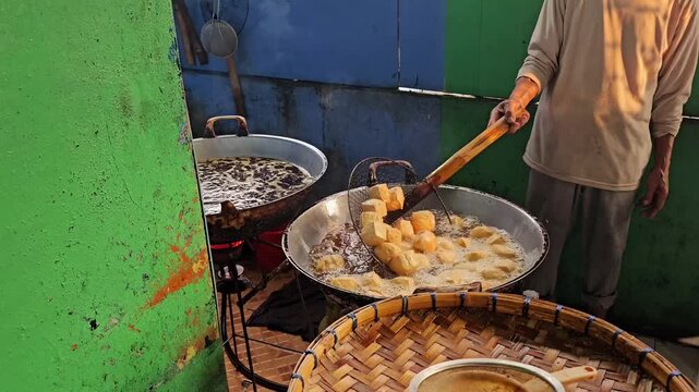 Indonesian Street Food Vendor Frying Tahu Petis in Large Pan