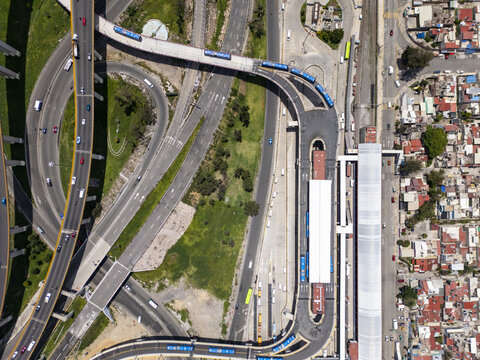 Aerial view of the train station and complex highway interchange with multiple lanes and vehicles in Mexico City, Mexico City, Mexico.