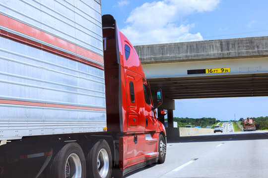 Truck travels under bridge on American highway