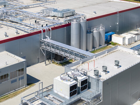 Aerial view of the OSM Bierun industrial facility featuring large metal storage tanks, complex piping systems, and rooftop ventilation units in Bierun, Poland.