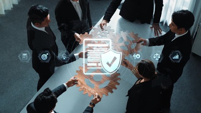 A diverse group of professionals collaborates around a table, focused on a digital interface showcasing security and data analysis symbols, symbolizing teamwork and innovation. Raster