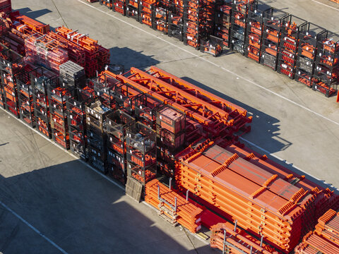 Aerial view of PERI Polska Sp. z o.o. construction equipment storage yard with stacked orange steel formwork components and metal crates in Jaworzno, Wojewodztwo slaskie, Poland.