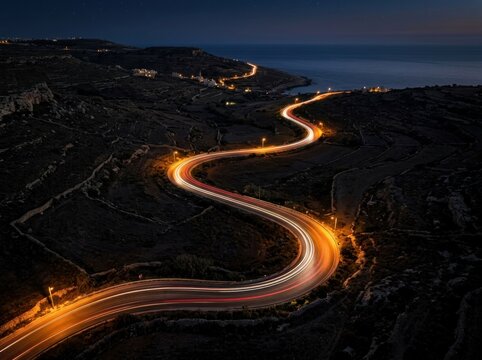 Long Exposure of a Winding Road at Night with Light Trails.