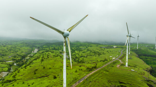 Wind energy turbines in green hills, India
Wind turbines and lush landscape, Maharashtra